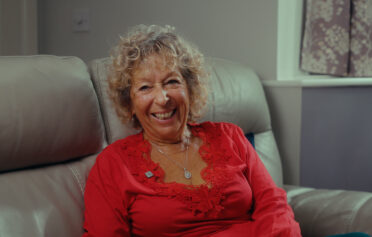 Happy woman sitting on sofa
